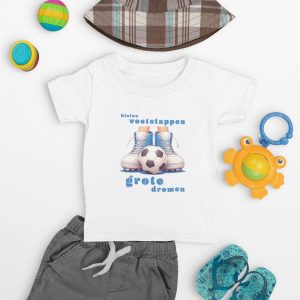 Wit/Rood kinder T-shirt met voetbalmotief: "kleine voetstappen, grote dromen", omringd door speeltjes en kindershort.